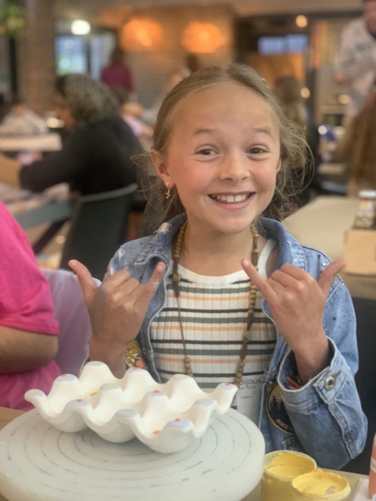 Young girl encouraging self-expression at the Clay Café in Hout Bay.