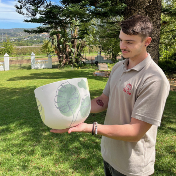  Happy customer with painted pottery at Clay Cafe in the City, great for hosting events.Title: Joyful Customer with Pottery - Clay Cafe in the City