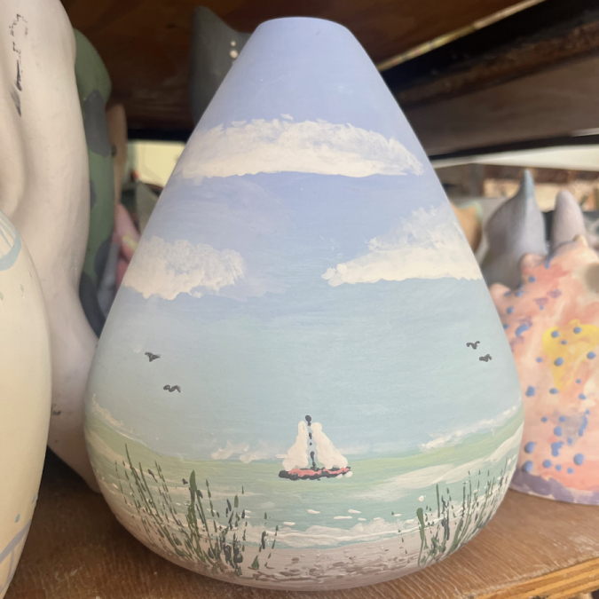 : Painted pottery vase with boats and sea from a creative session at Clay Cafe Cape Town.