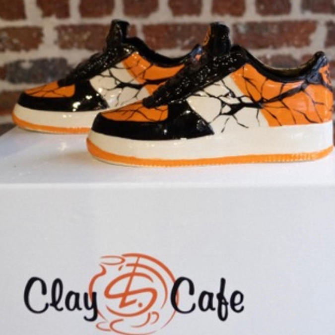 Colourful painted shoe designed during pottery painting at Clay Cafe, great for family-friendly events.