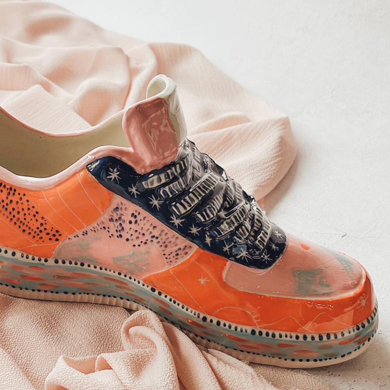 Uniquely painted shoe from a group activity at Clay Cafe, ideal for family-friendly events.Title: Painted Shoe - Group Activity at Clay Cafe