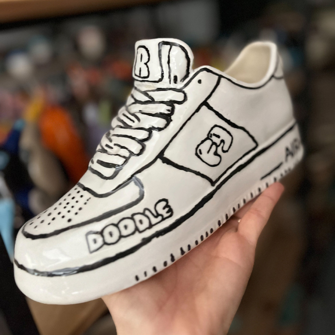  Painted shoe from a Paint & Donate event at Clay Cafe, supporting local charities.