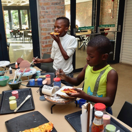 Participants painting pottery at Clay Café’s Paint and Donate event for local charities